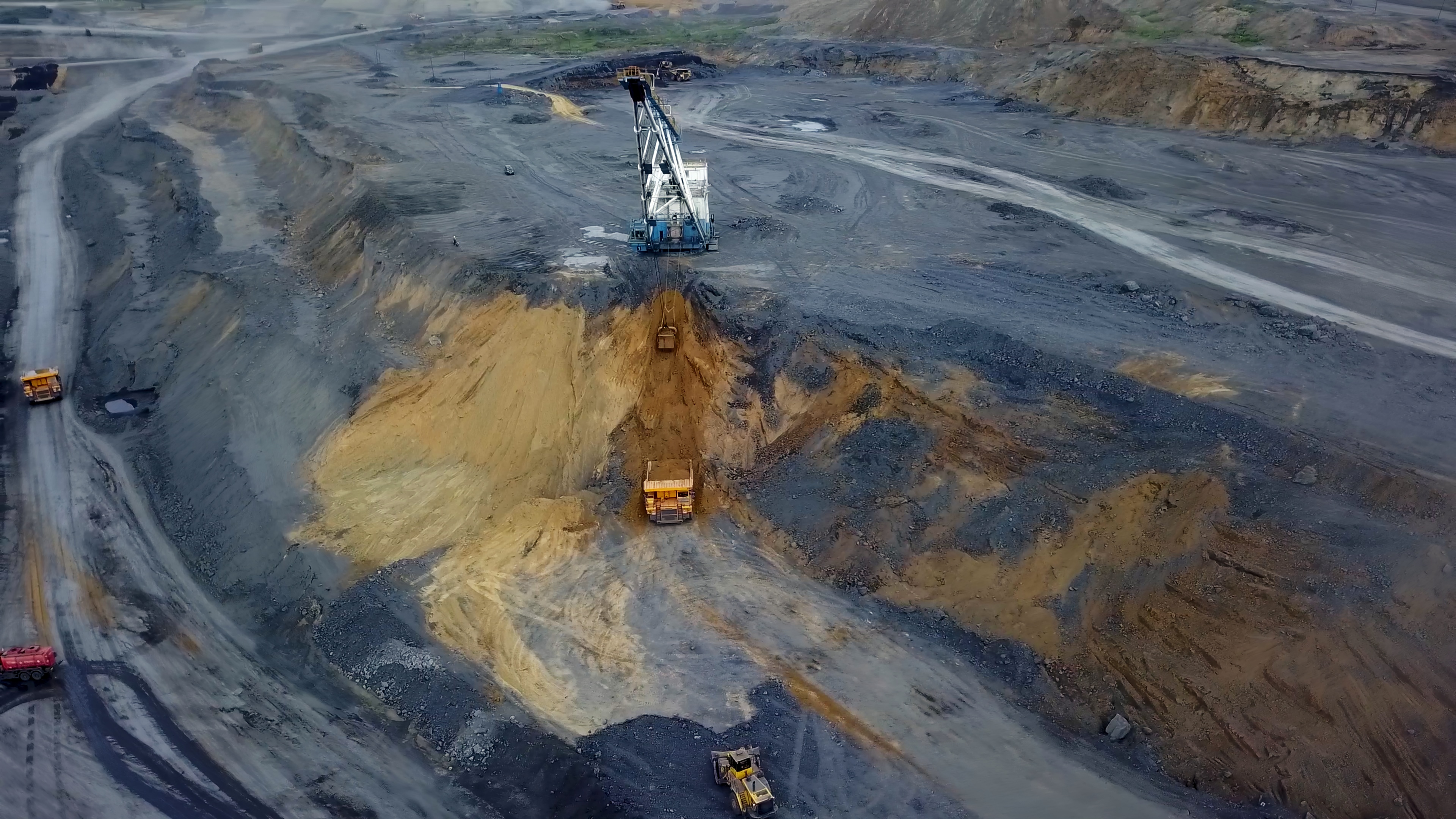 aerial-view-reveals-a-vast-mining-operation-with-heavy-duty-excavators-working-intense