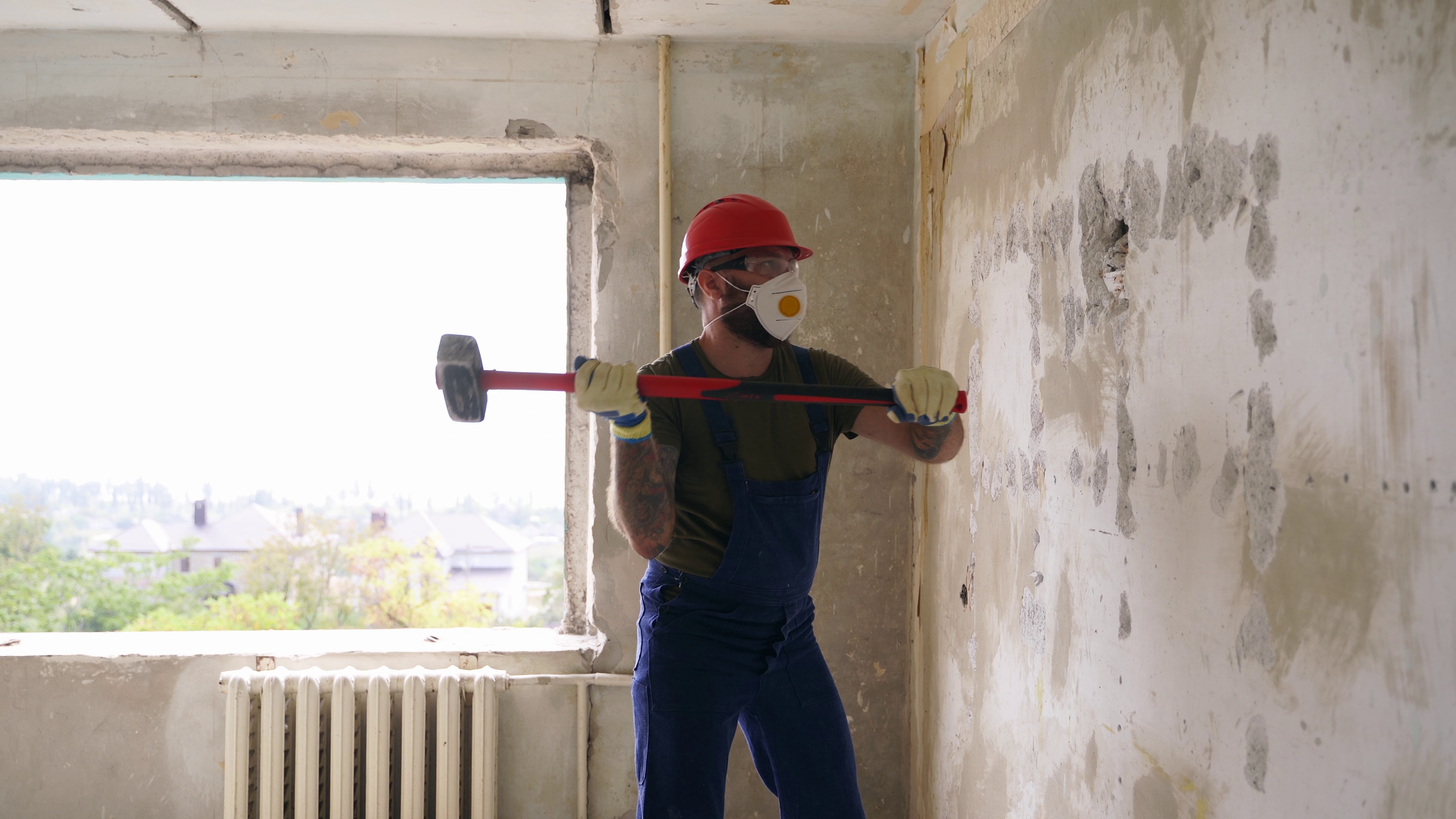 contractor-wrecks-concrete-wall-with-sledgehammer-for-rearrangement-man-doing-manual