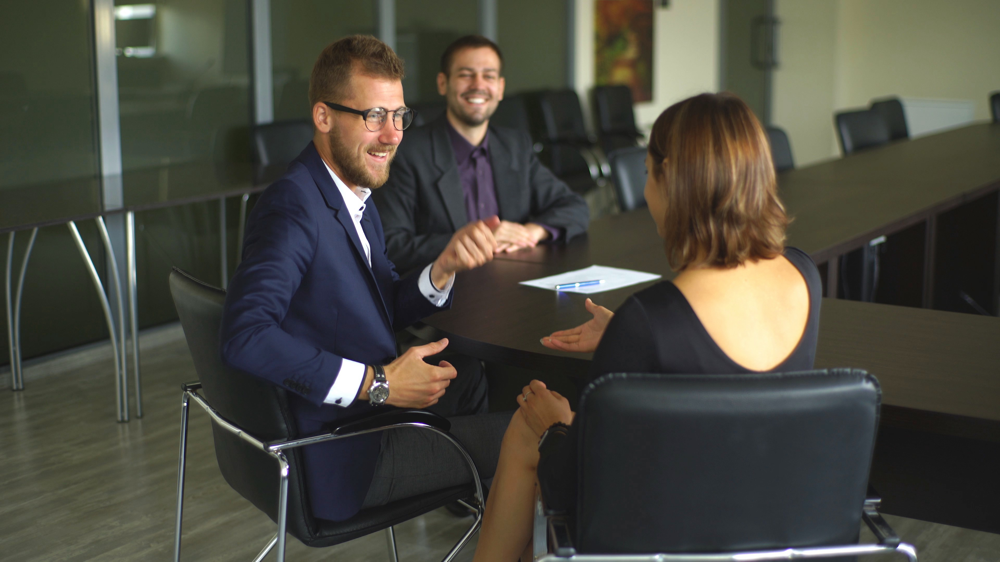 male-realtor-with-key-and-young-couple-from-back